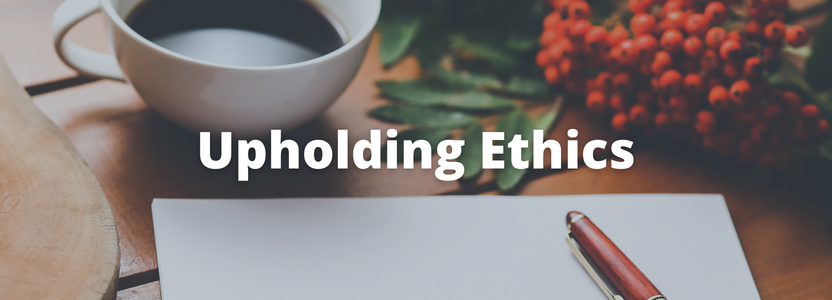 Upholding ethics, image of a table with a mug, paper and pen on it.